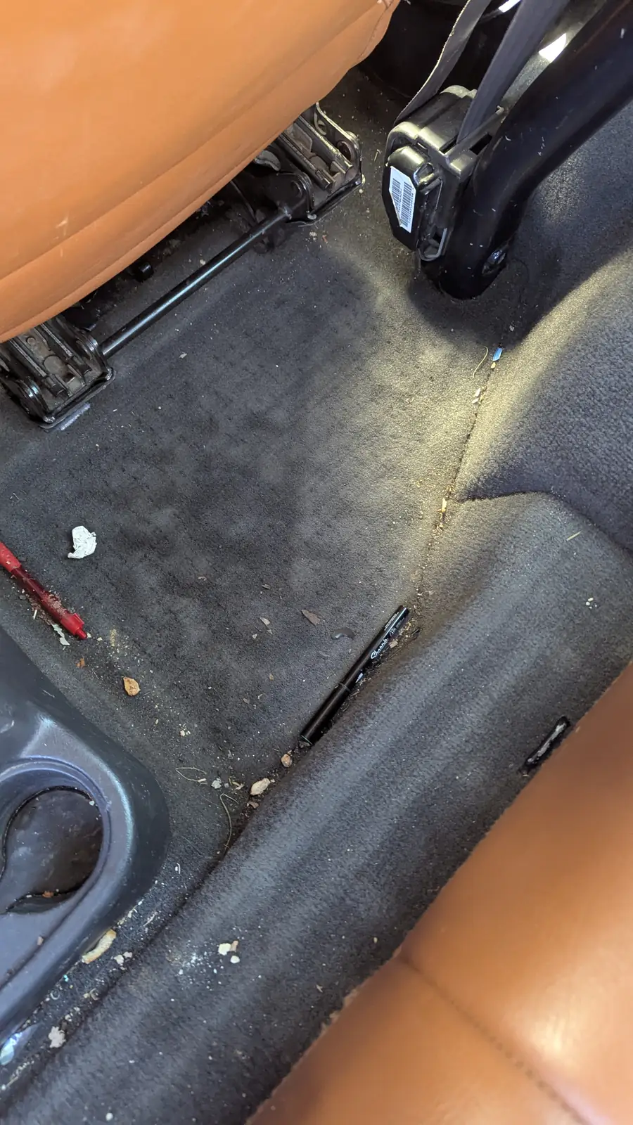 Dirty carpet and footwell before detailing